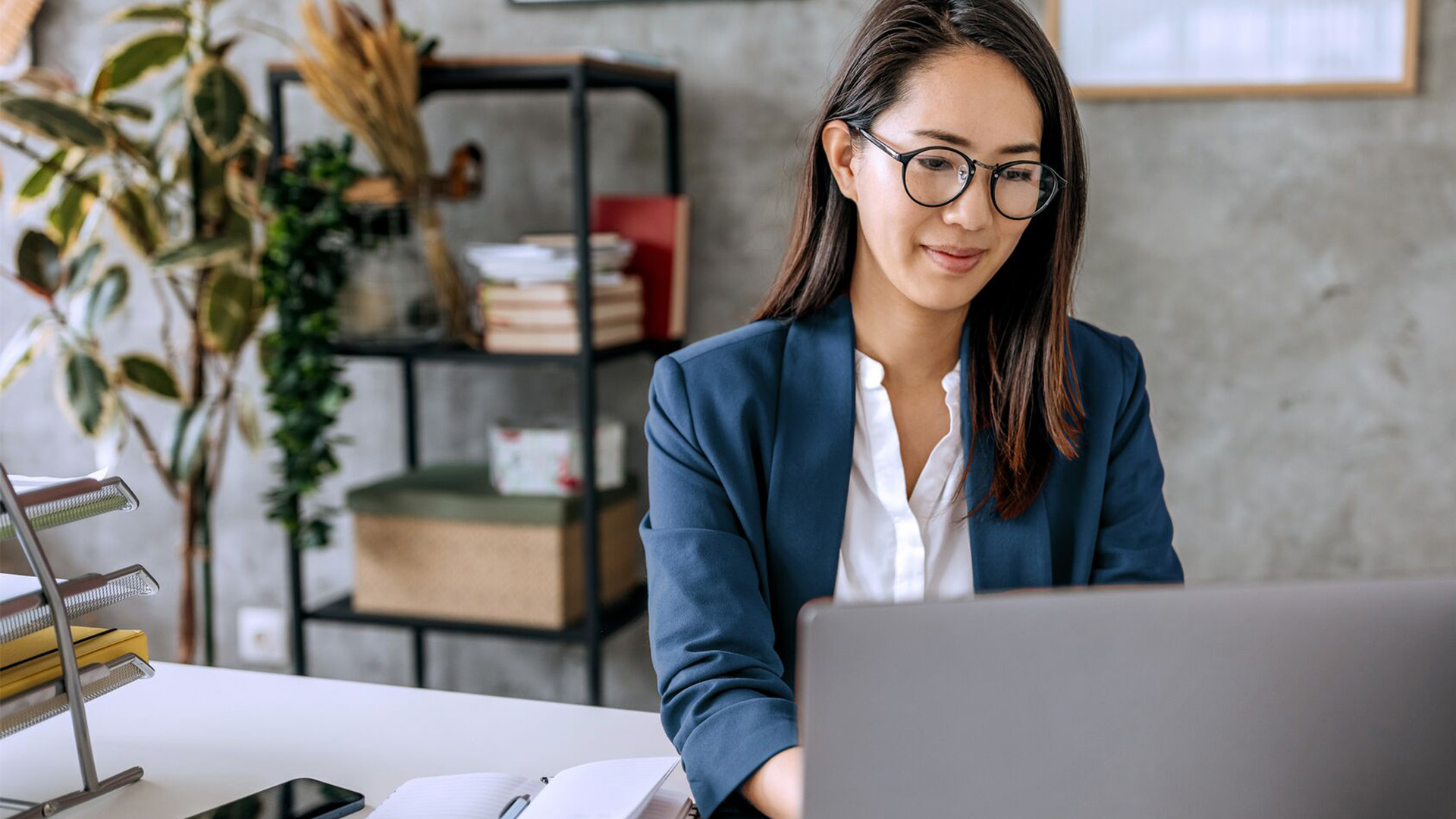 A business woman working from her home office on a laptop.