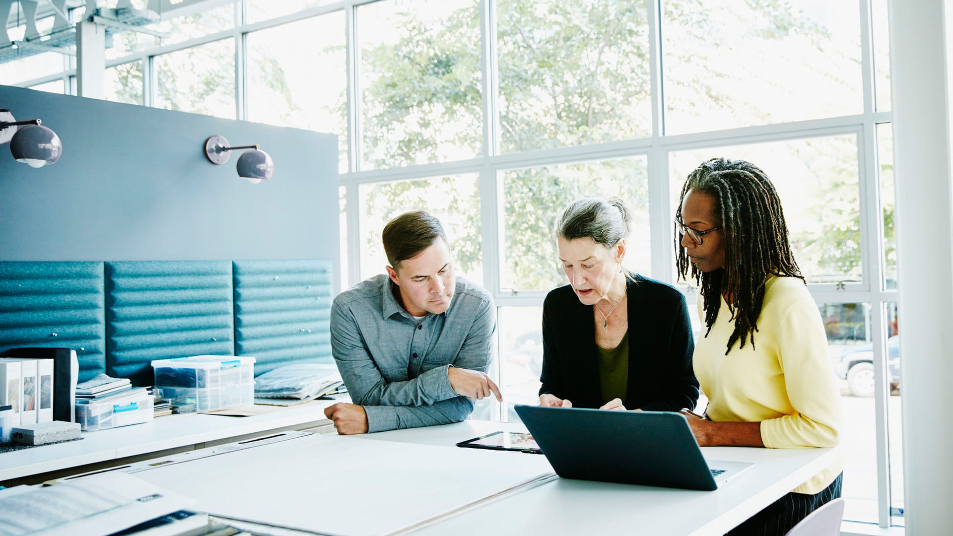 A designer leading a project discussion with her colleagues