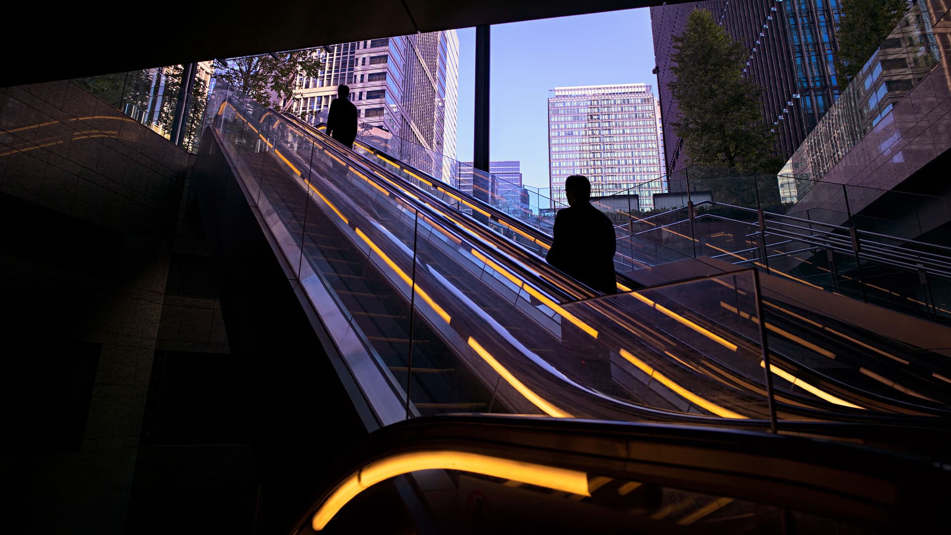 Individual riding an external escalator.