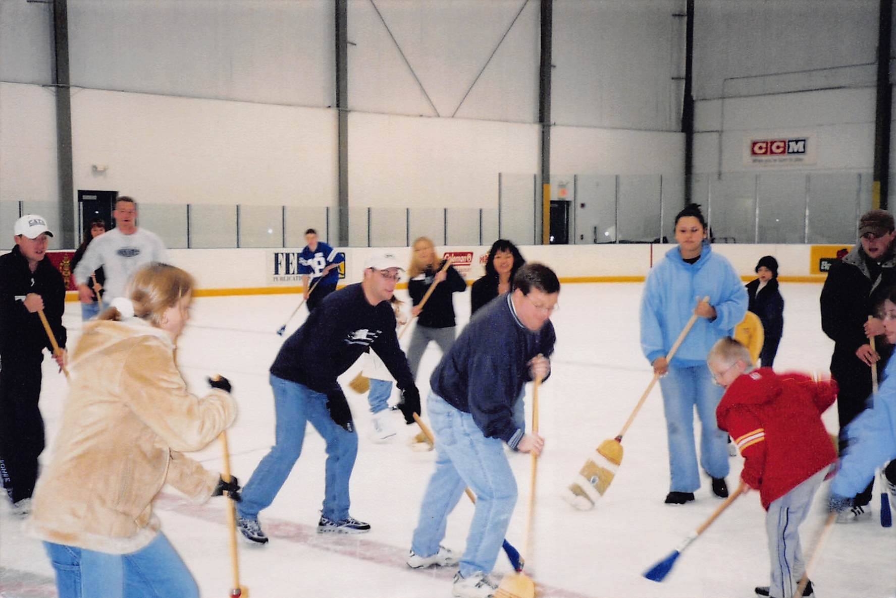 Bill Pickert and family playing ice hockey with broom sticks..