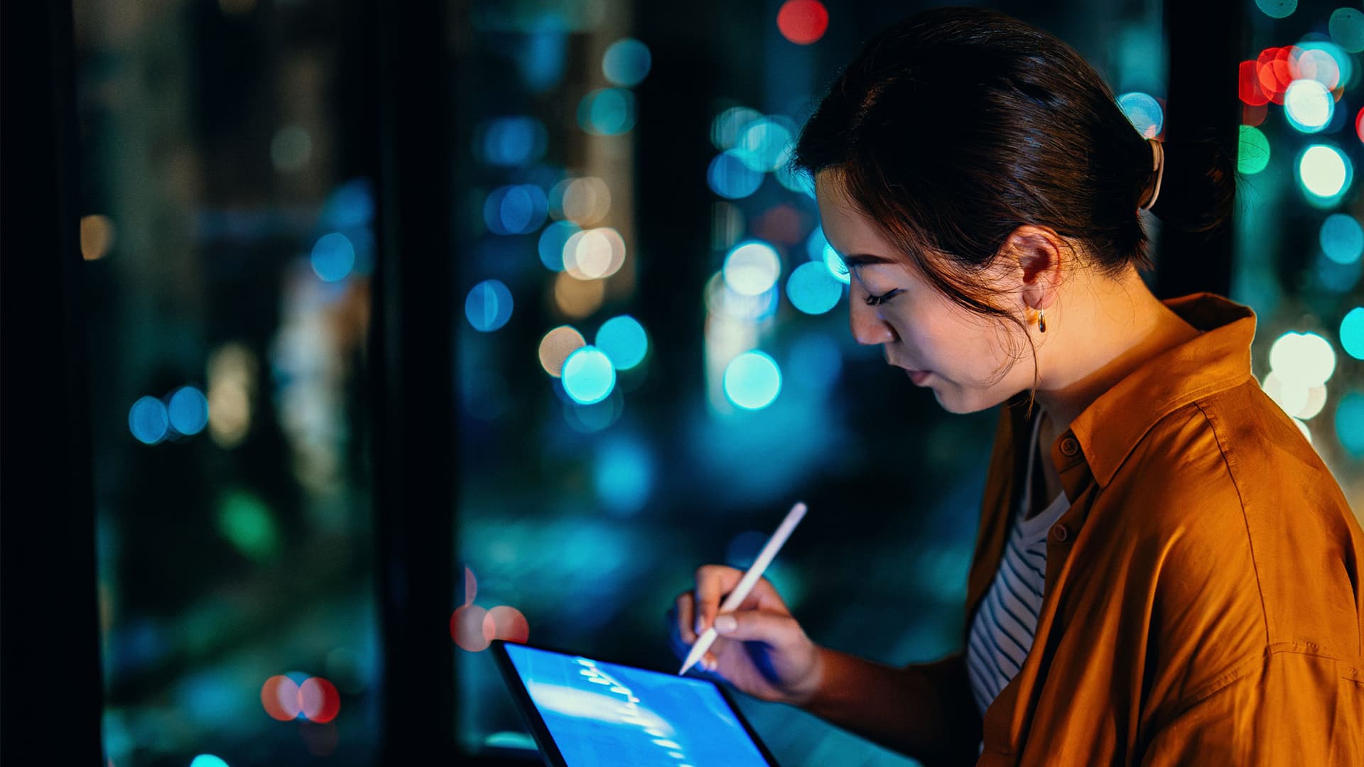 A woman working from home on her tablet.