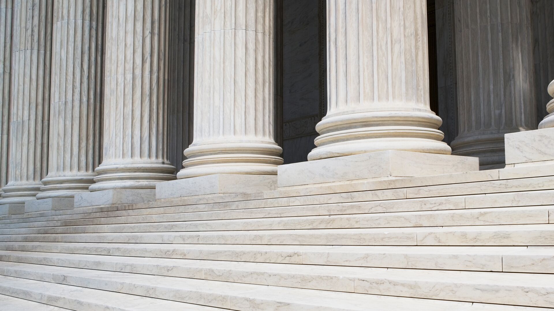 The front steps of a building followed by row of columns