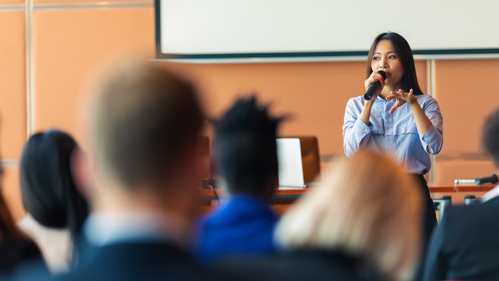 A woman presenting at a meeting.