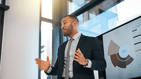 A professional business man speaking during a meeting.