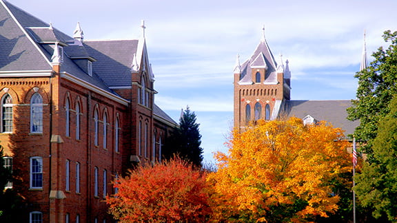A college campus during the fall season with trees and buildings