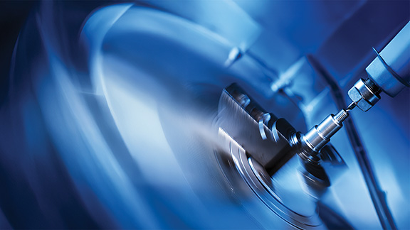 Close up of a machine drilling into metal.