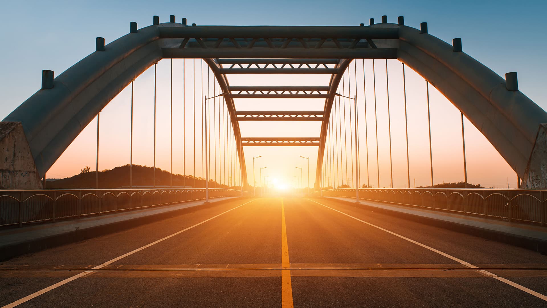 A suspension bridge at sunset.