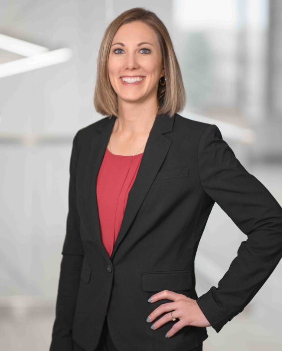 Kim Keller smiling for a professional photo..