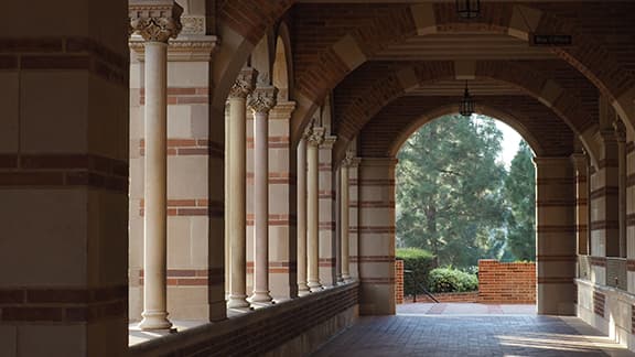 An outdoor hallway with brick floors and ceilings