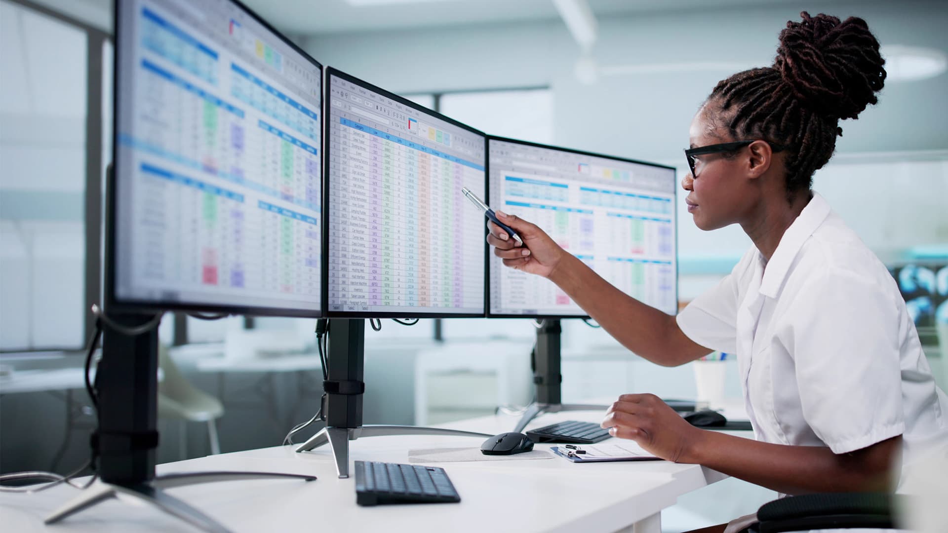 Hospital Doctor Using Spreadsheet For Billing Codes On Desktop