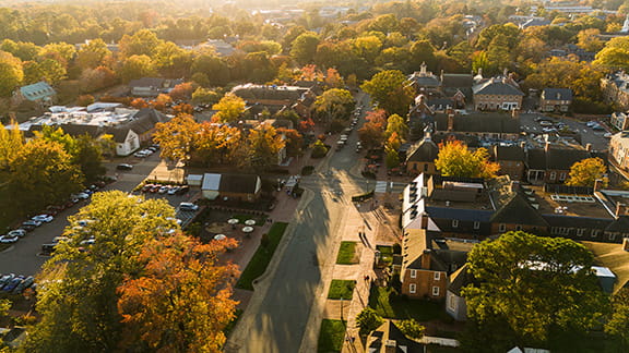 A sunset that shines above a small neighborhood in Colonial Williamsburg, Virginia