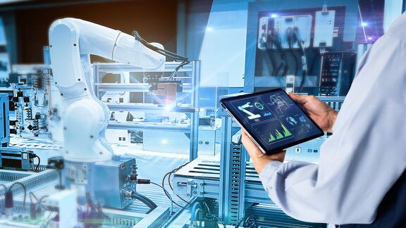 A maintenance worker looking at a tablet.