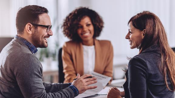 A couple discussing senior living homes with a professional.