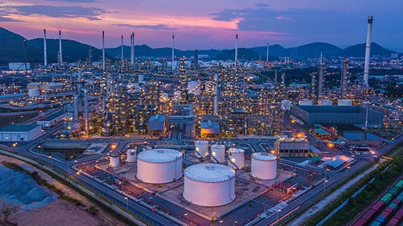 A giant oil and gas chemical tank plant at dusk