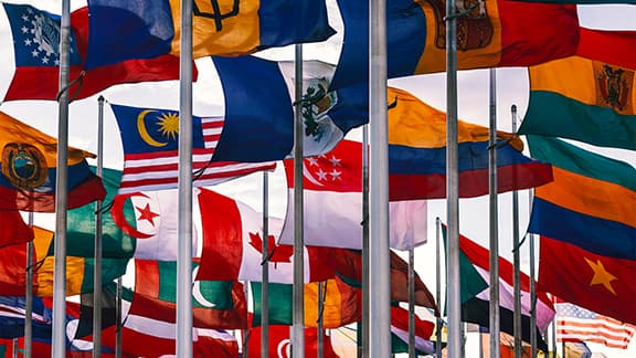 Flags of different nations waiving on high flagpoles