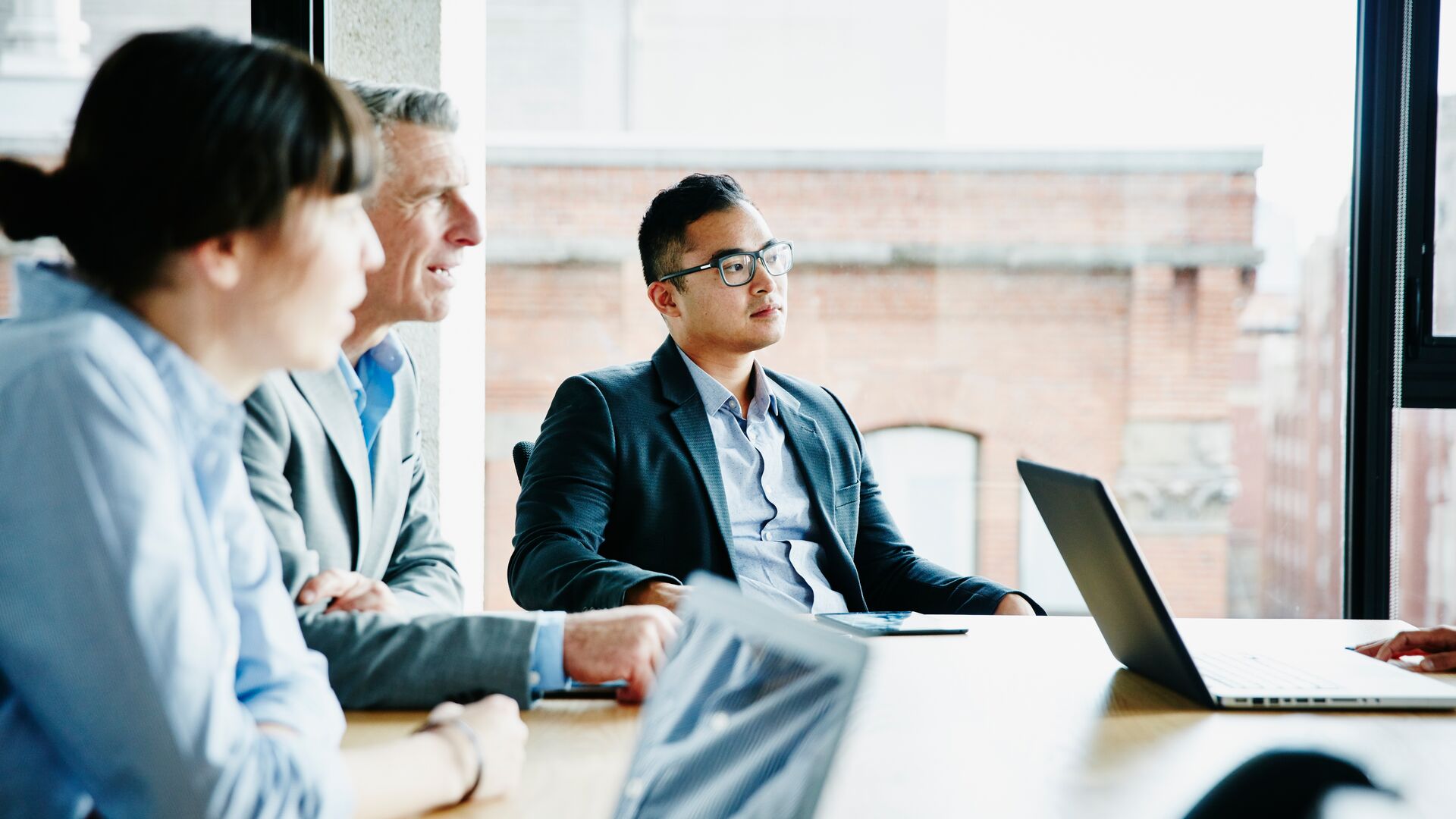 Businessman listening to presentation during project meeting in office