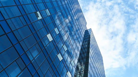 Exterior of a shiny, high rise building in a city.