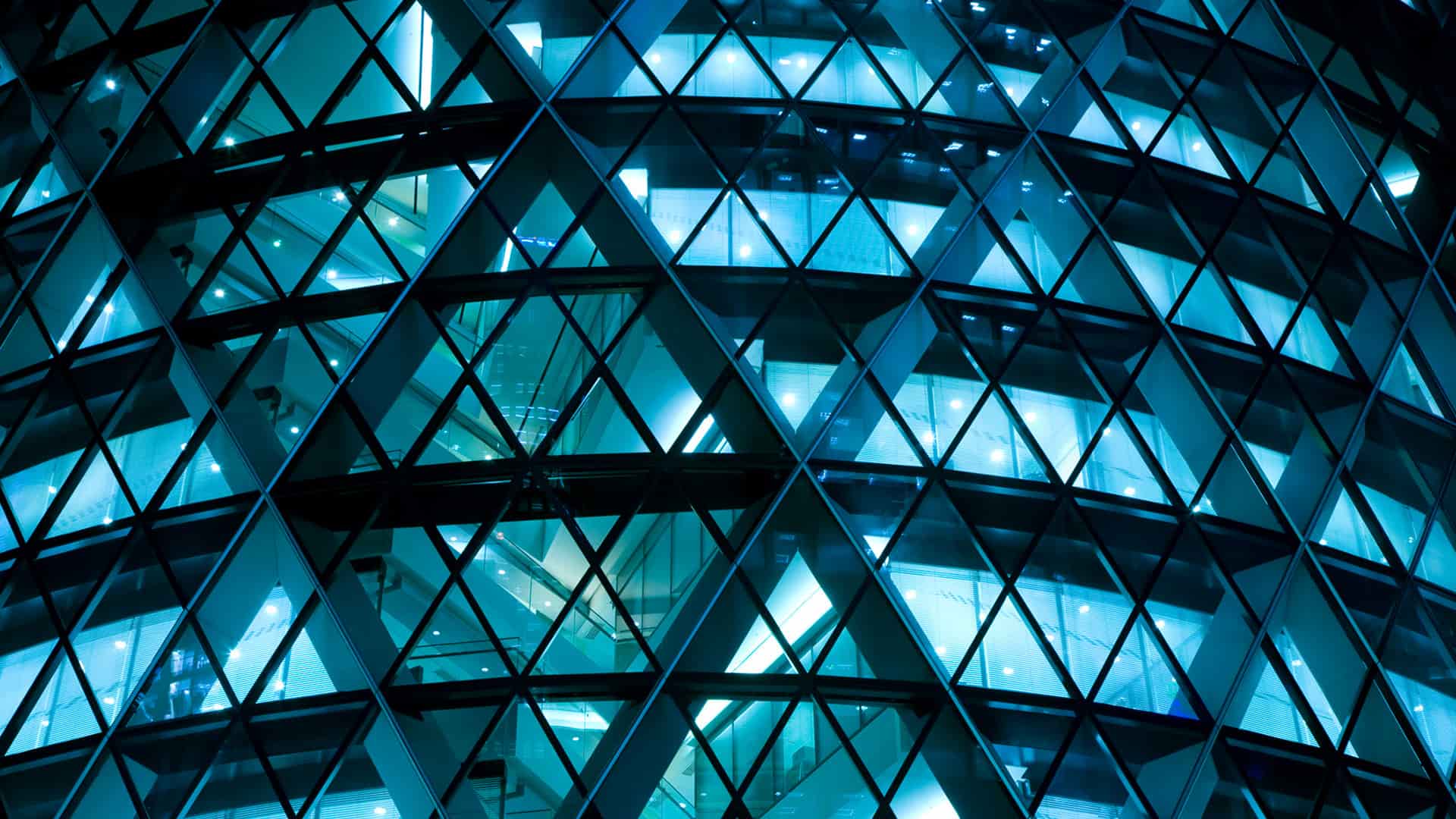 Glowing, futuristic office building at night.