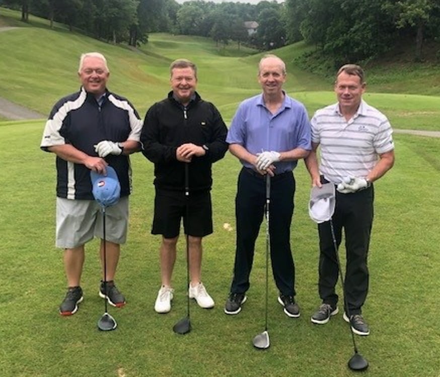 Bill Pickert and co workers playing golf.