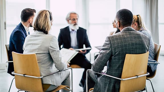 Professional healthcare workers meeting together in an office.