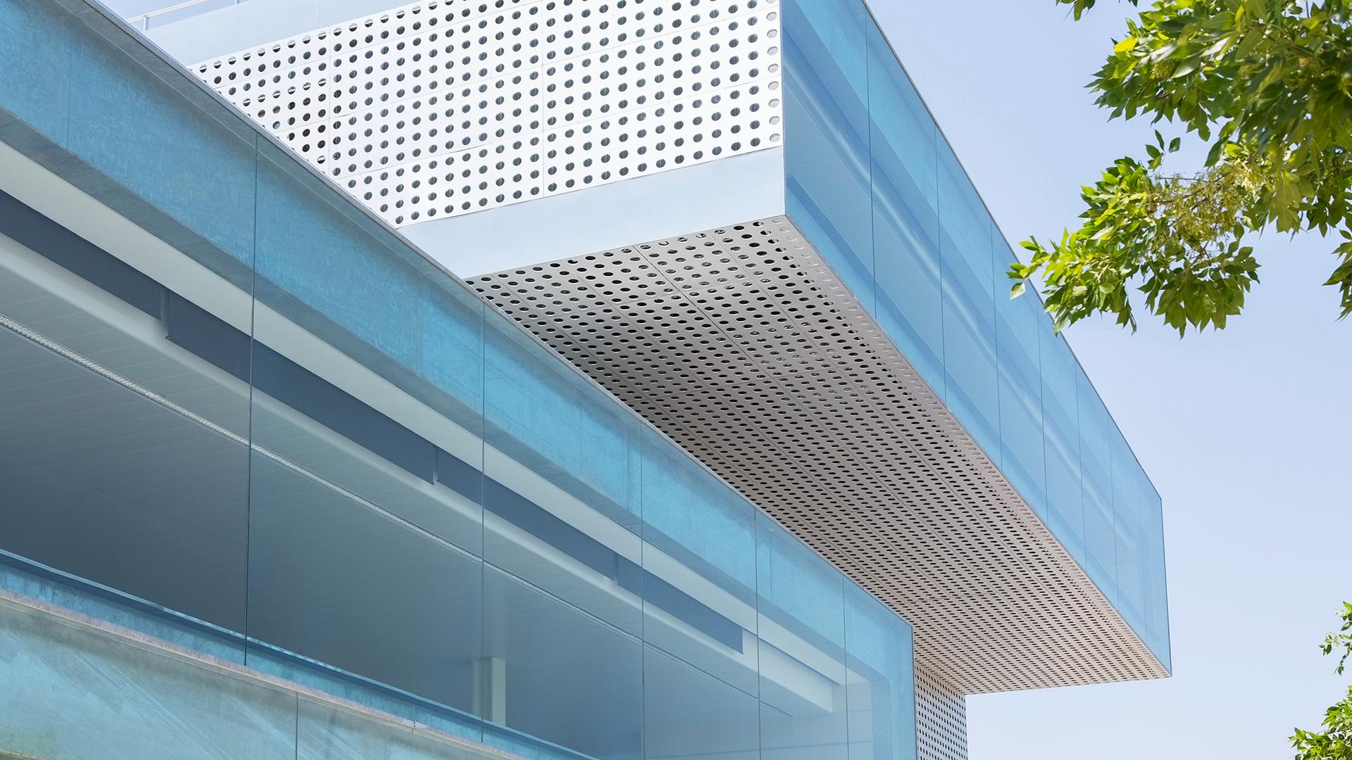 Cool modern exterior architecture with trees in the background.