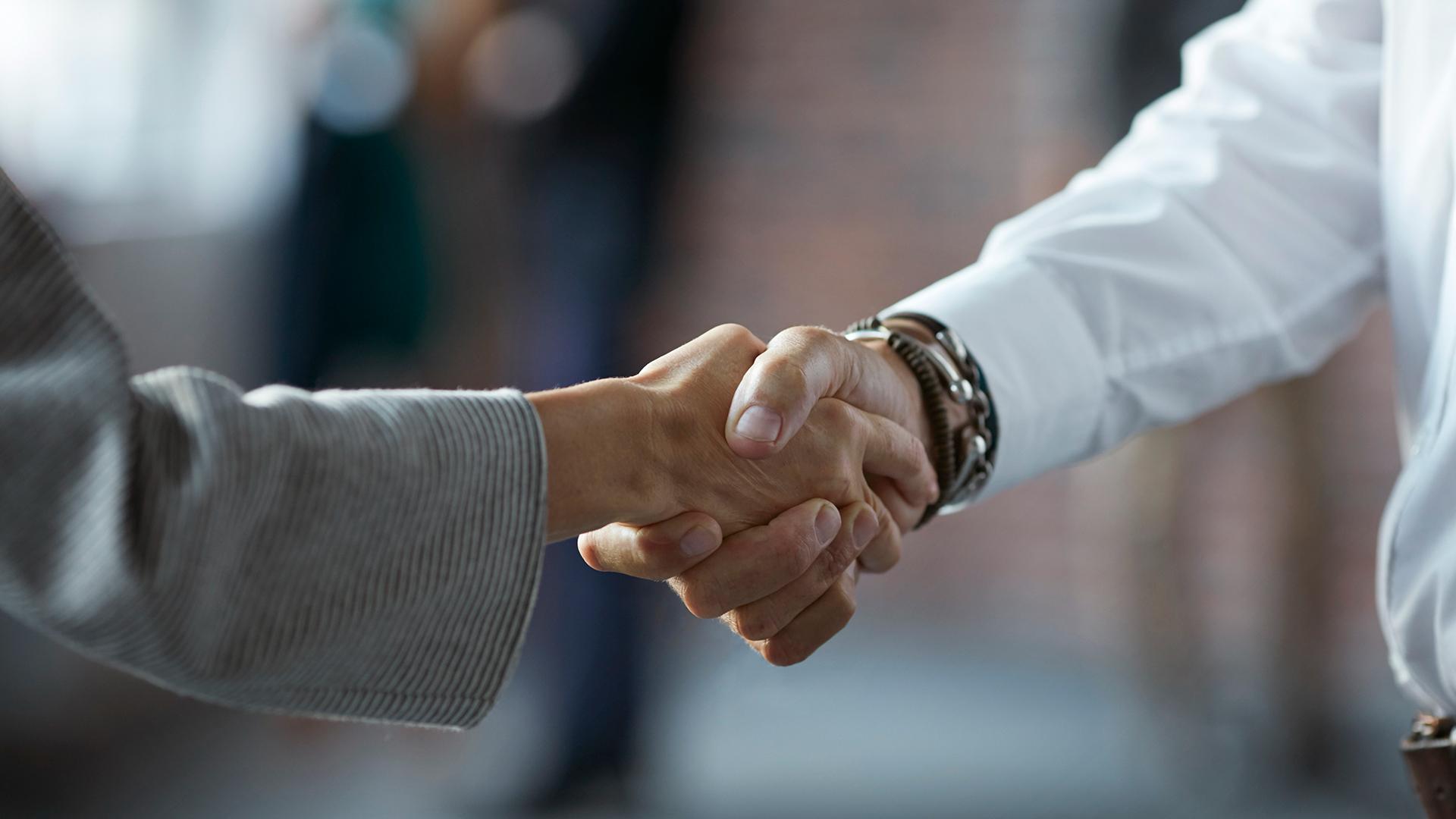 Two business workers shaking hands.