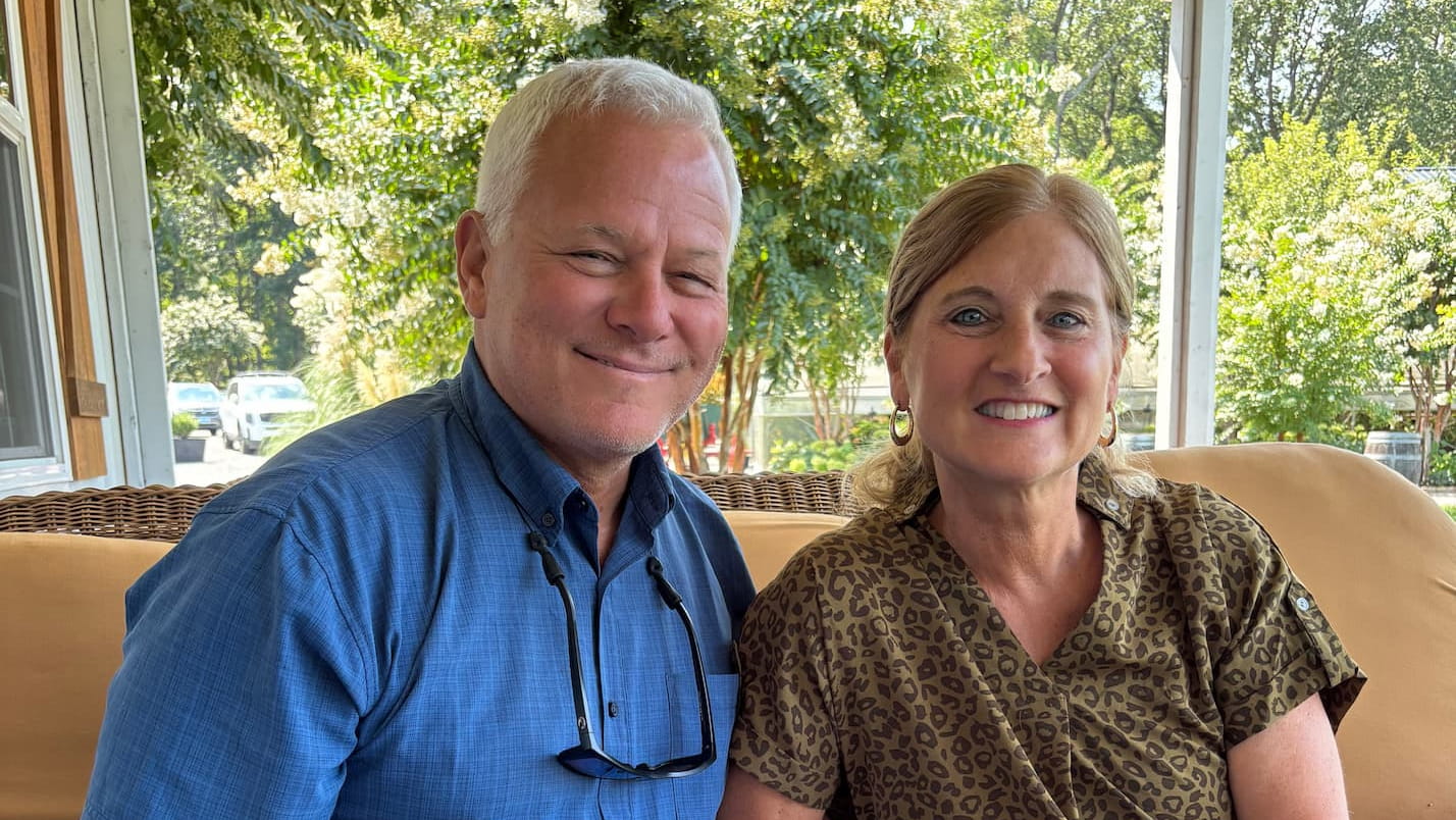 Lori Haley sitting with her husband.