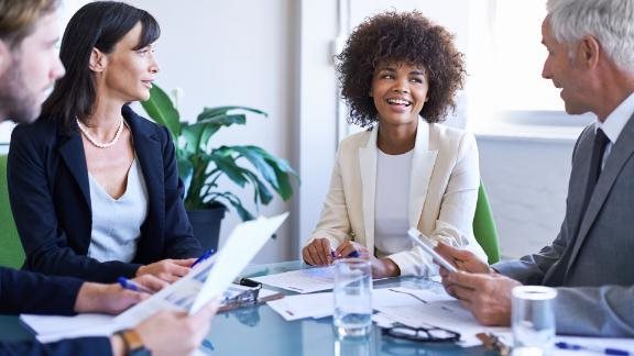 Business professionals gathered in a conference room.