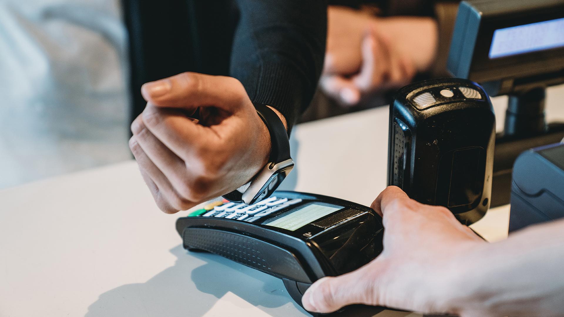 Detail of a man paying contactless with his smart watch