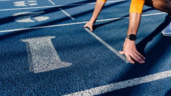 Athlete at starting line of running track