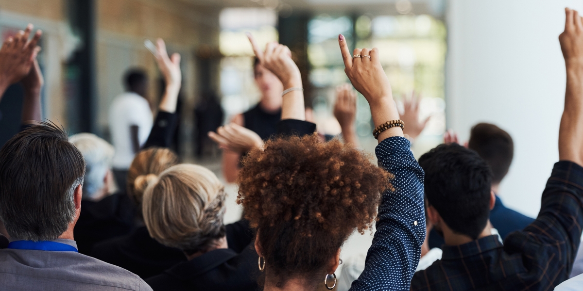 Hands raised in a conference meeting