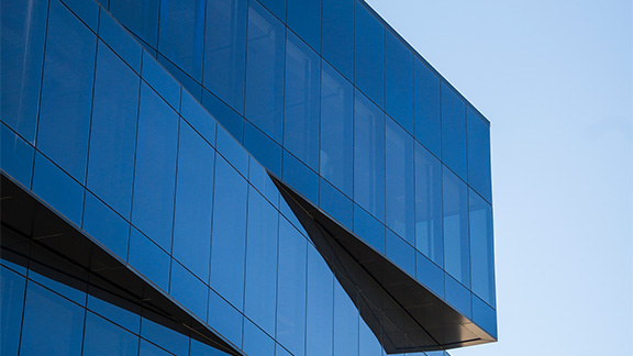 A modern looking office building against the blue sky