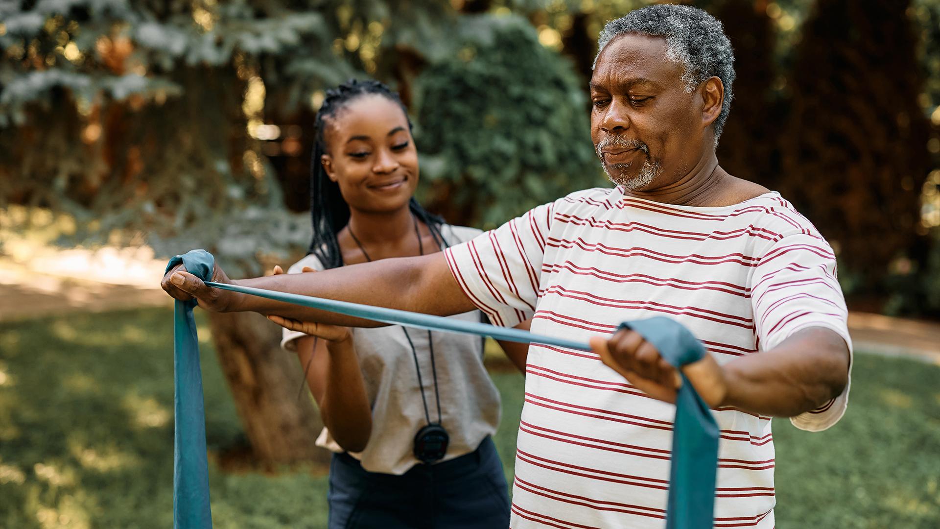 A physical therapist helping a senior patient.