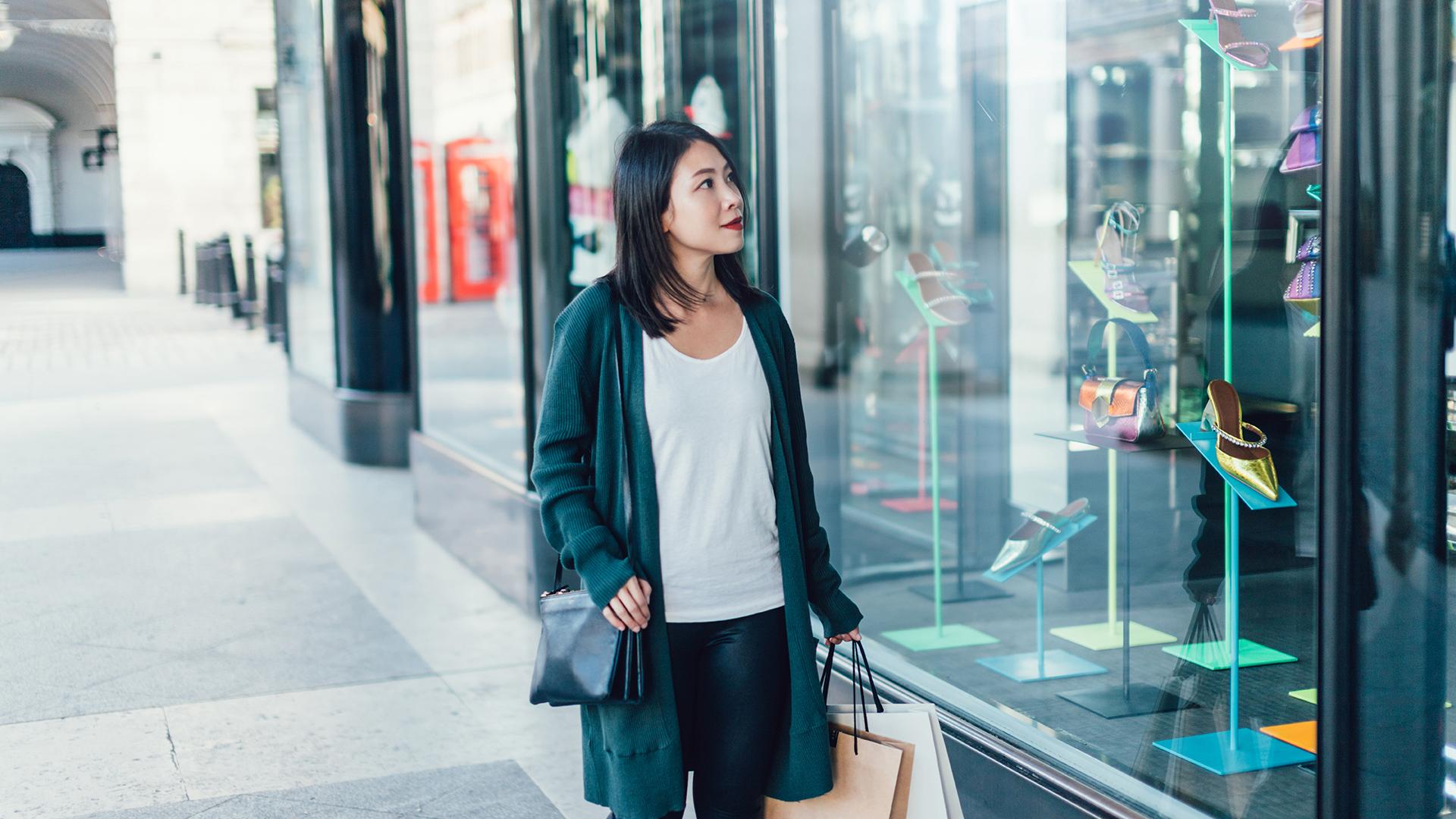Young Woman Window Shopping On City Street