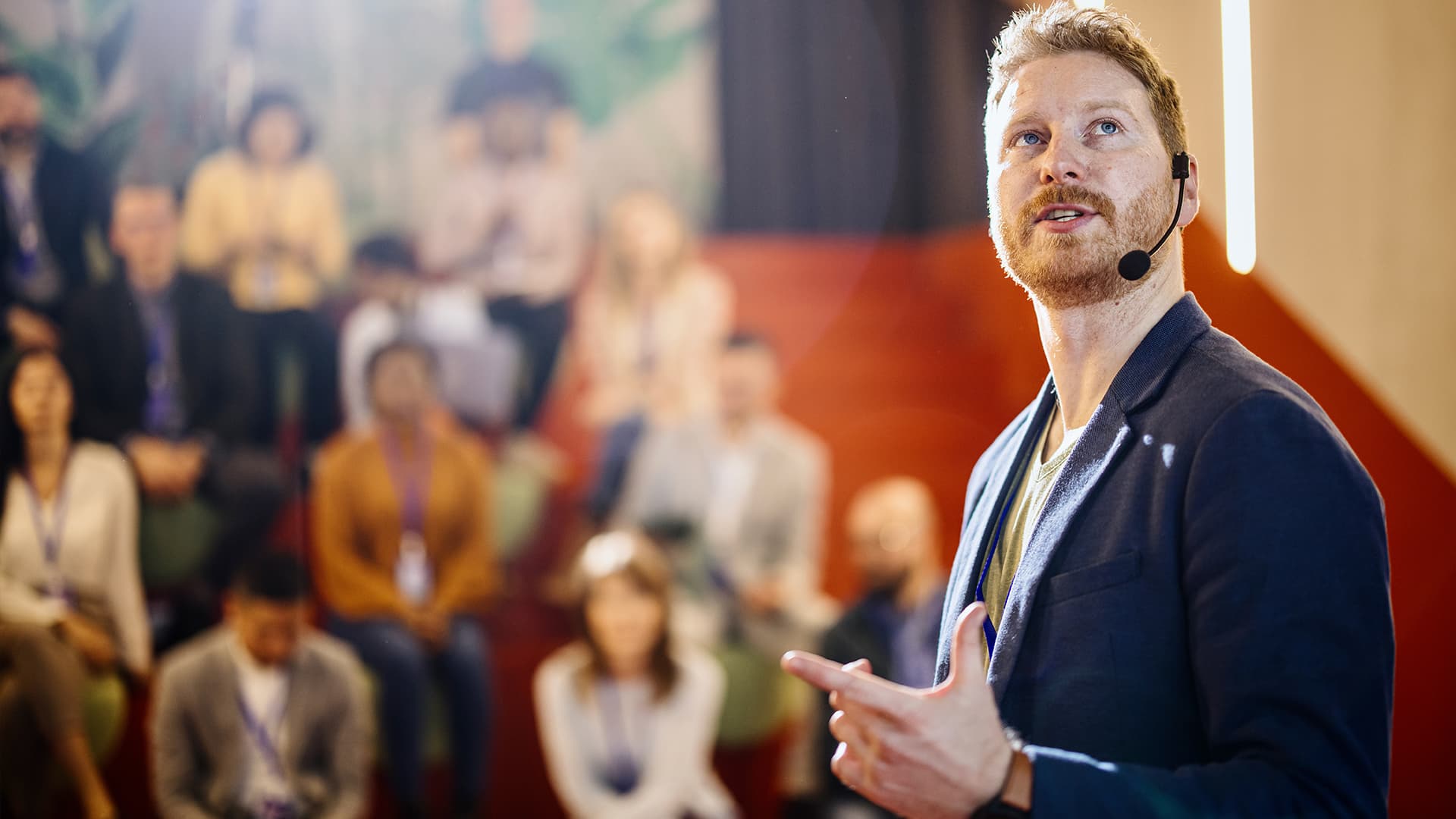A man presenting at a conference.