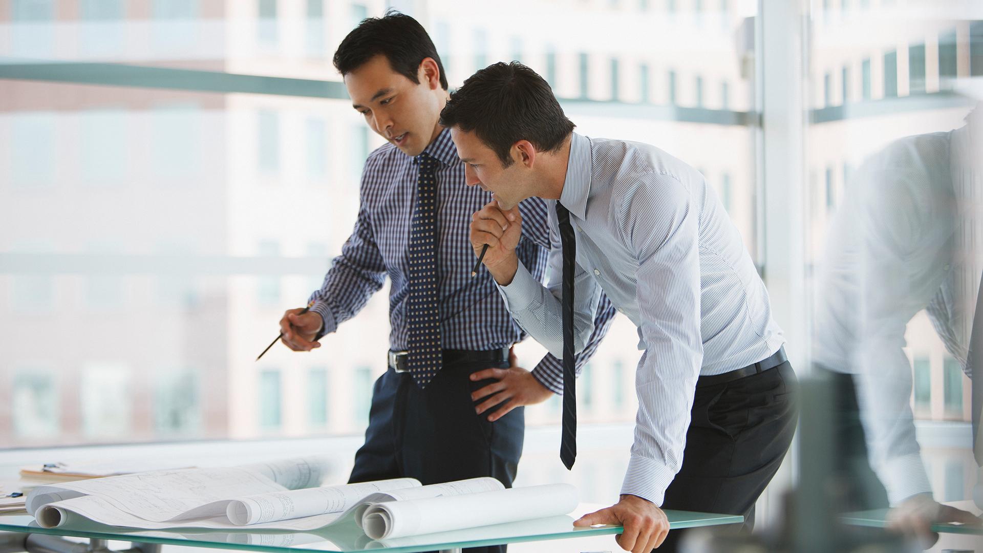 Two business professionals working closely on a project together.