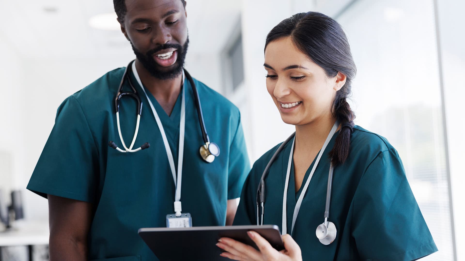 Healthcare workers looking at a patients chart together.