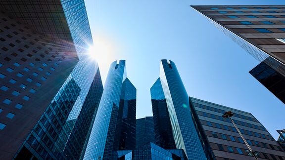France, Paris, La Defense, low angle view of brightly lit modern office buildings in daytime