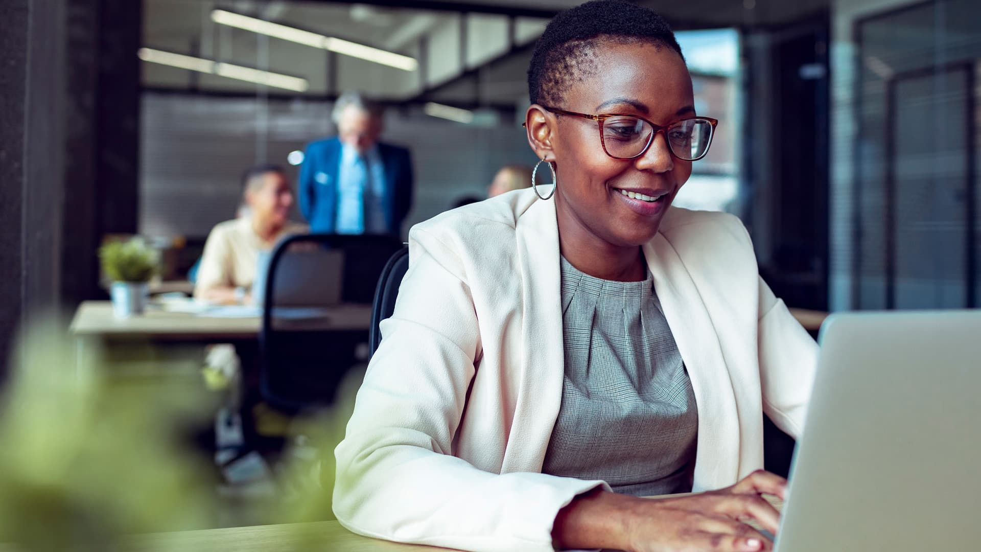 A woman working on her laptop in the office.