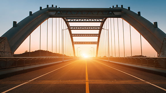 A suspension bridge at sunset.