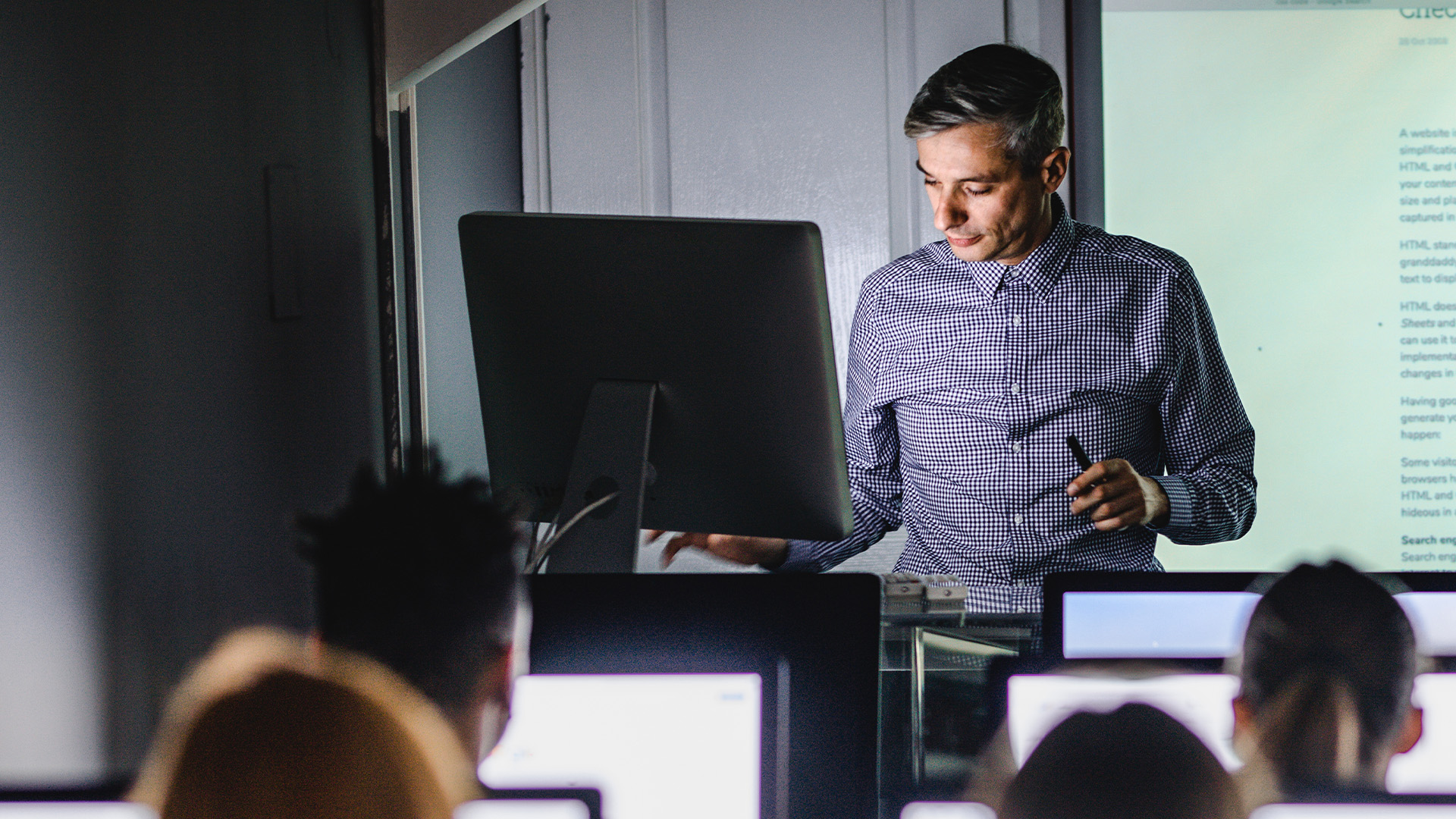 A man leading an education cybersecurity lecture at a school.