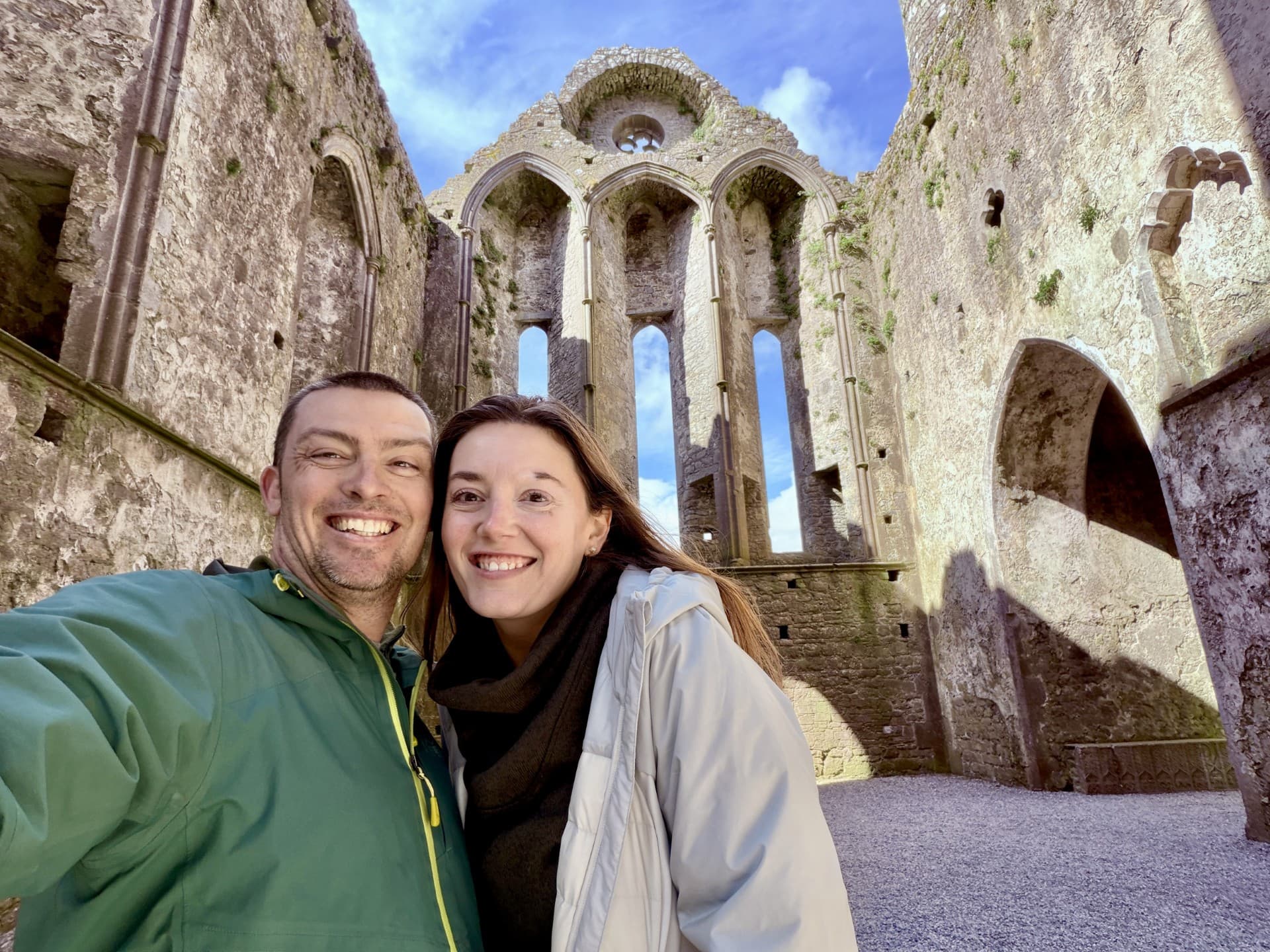 Kayla Reynolds and her husband in front of ruined ancient architecture.