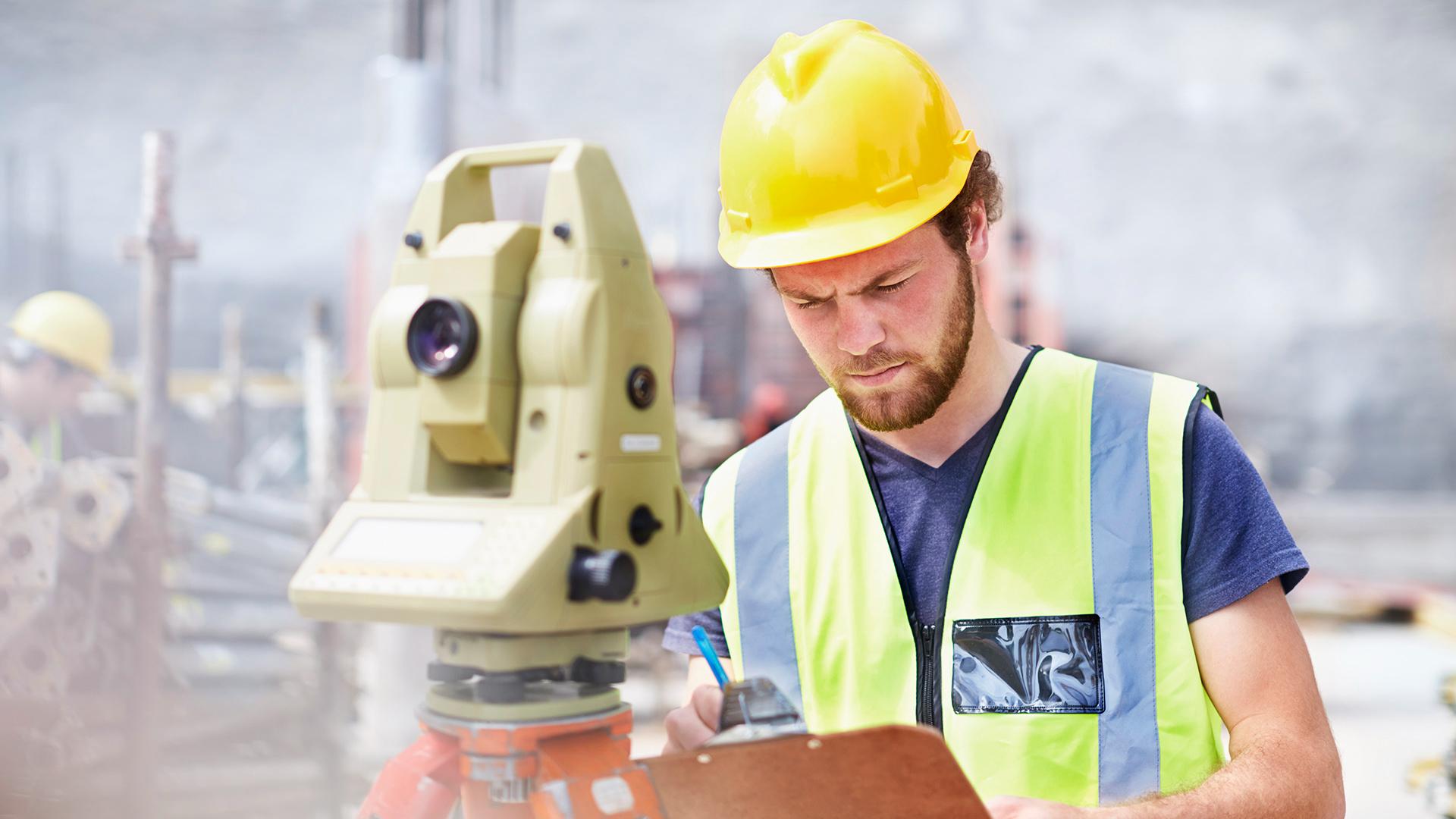 An engineer holding a clipboard while working at a construction site