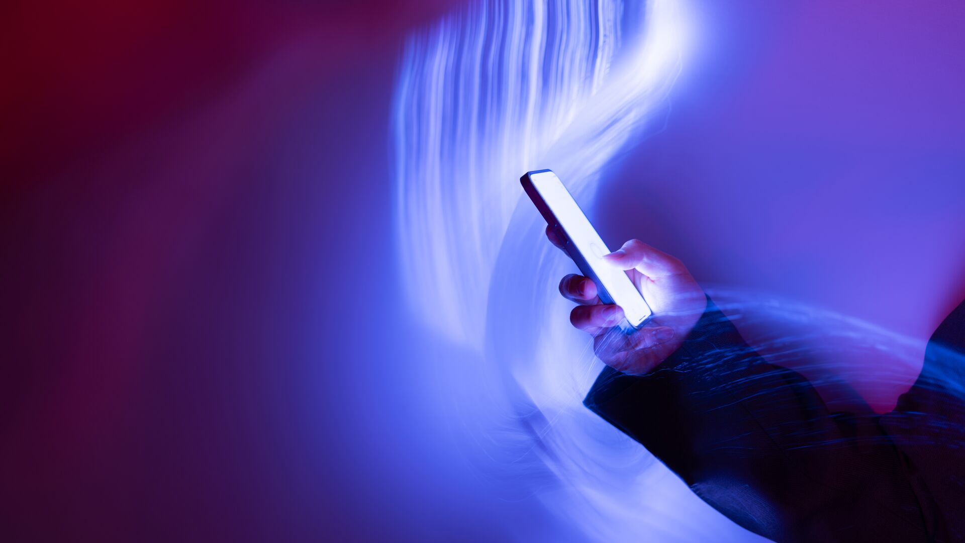 A person using a mobile phone on a holographic background