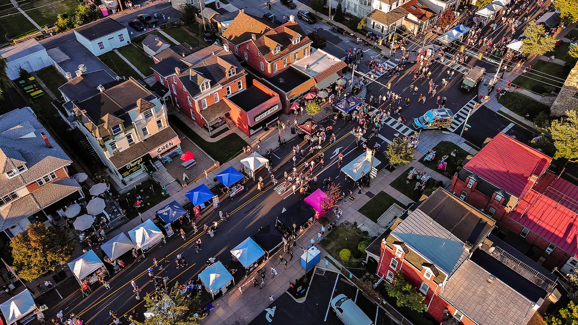 Autumnal town street packed with festivities