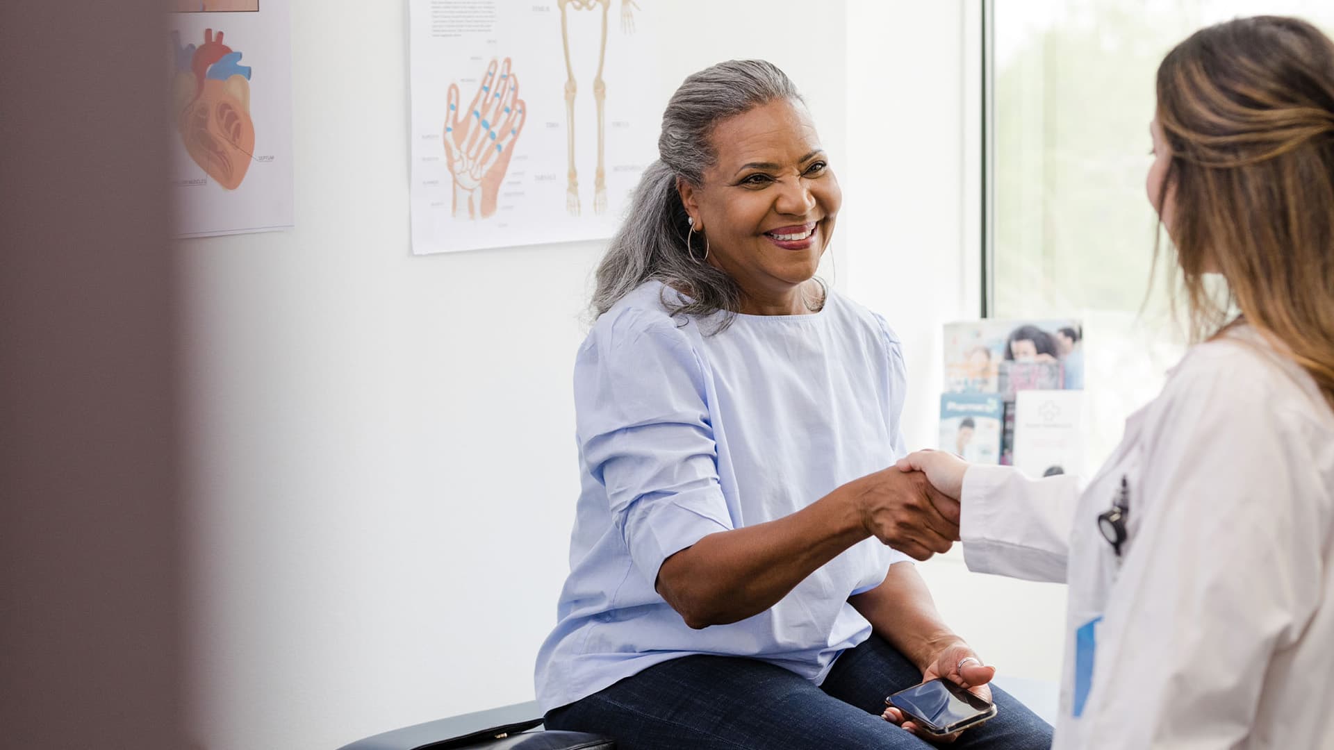 A doctor that is shaking hands with a patient