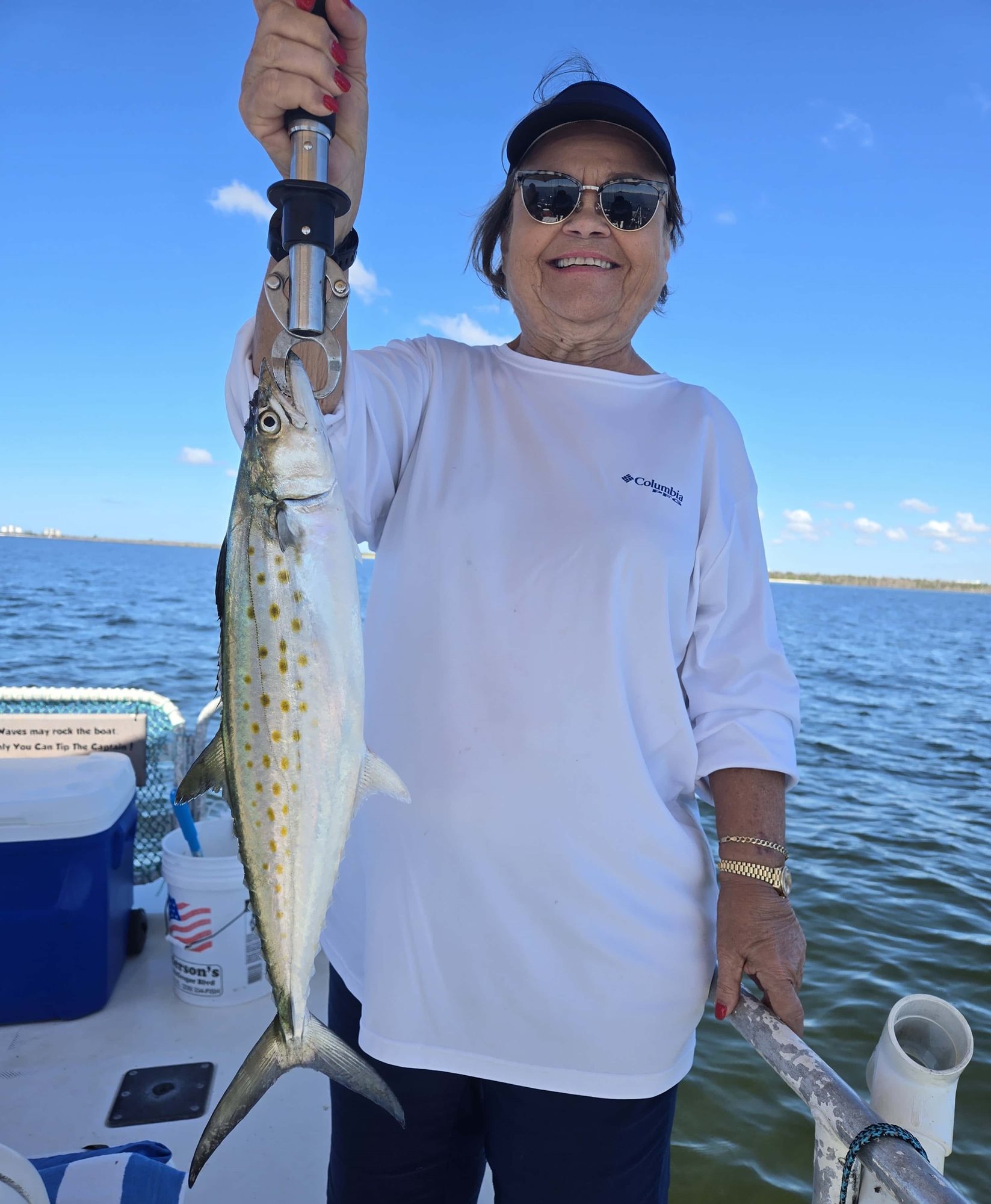 Judy holding up a large fish that she caught.