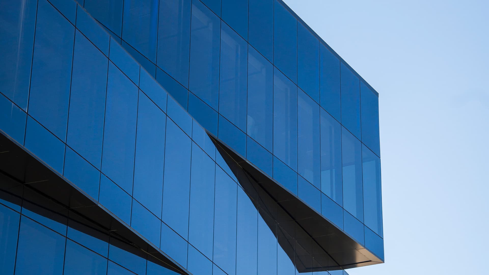 A modern looking office building against the blue sky
