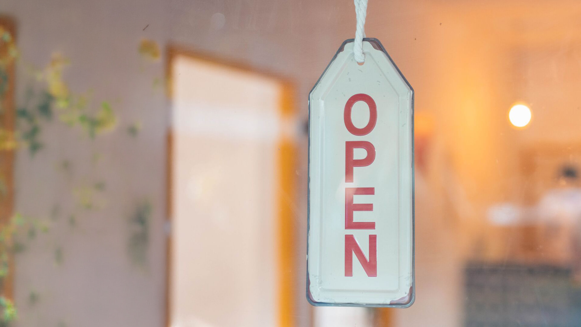 Store open sign hanging on the window.