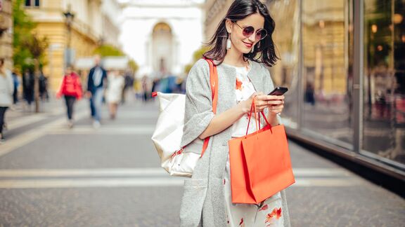 A woman out shopping in a downtown district.
